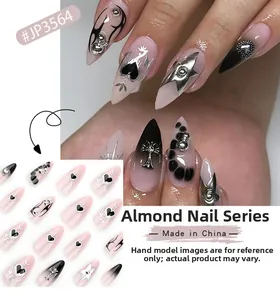 Macro detail of almond-shaped nails featuring black hearts and 3D metal cross accents