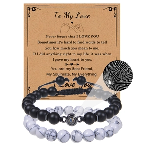 Detail of I Love You projection bead on couple's matte stone bracelets with gift card