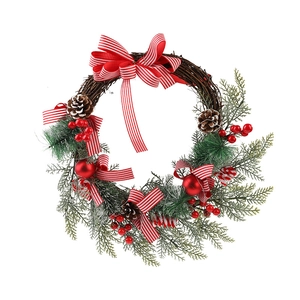 Christmas wreath with red berries, pine cones, and striped ribbon on white background
