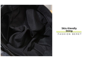 Detailed macro view of the skin-friendly inner lining and craftsmanship of the black beret
