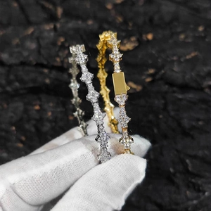 Detail of silver and gold tennis bracelets with cross motifs and sparkling cubic zirconia