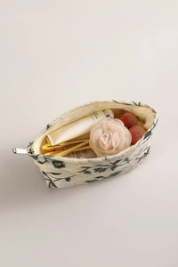 Top view of floral embroidery cotton linen makeup bag with cosmetics inside