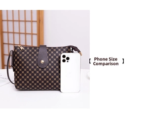 Detail view of printed crossbody bucket bag with leather flap compared to a smartphone