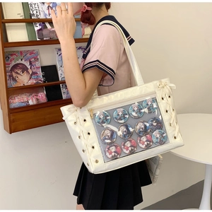 White ita-bag with clear PVC window and cross-laced side detail shown on shoulder