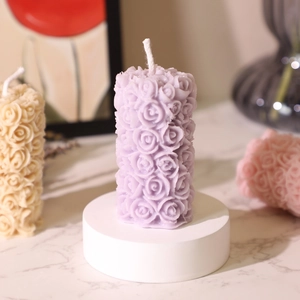 Handcrafted purple rose carved pillar scented candle with floral relief on white stand