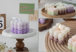 Detailed view of multi-color gradient rose flower shaped candles with elegant silk ribbons