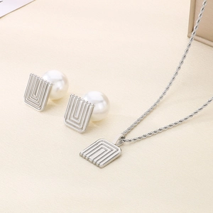 Detailed view of silver titanium steel jewelry set with square pearl earrings and necklace