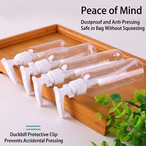 Set of four clear PET plastic travel bottles with white pump heads and safety clips