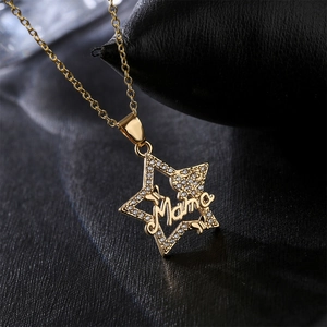 18K gold plated necklace with star pendant and Mama inscription on textured background