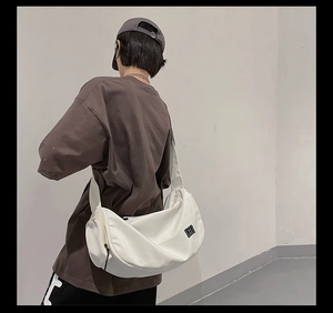 Detailed back view of a white large capacity nylon gym bag with wide shoulder strap