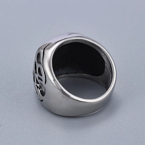 Close-up of unisex stainless steel ring with vintage skull carvings and brushed finish