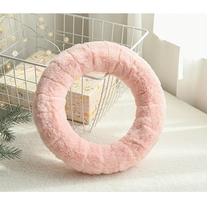 Pink plush wreath donut with embossed checkered pattern and festive lights decoration