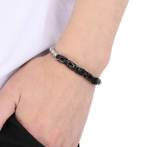 Detail of masculine Byzantine V-shape chain bracelet in black and silver stainless steel