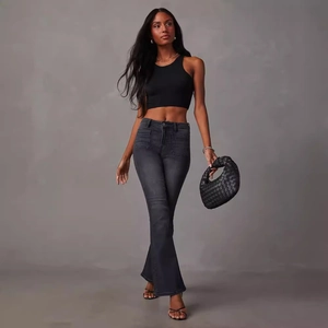 Women's dark grey flare denim jeans paired with a black ribbed crop top and handbag