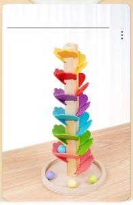 Close-up of colorful wooden petals on the music tree track with descending rolling balls