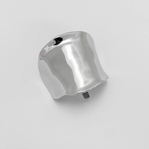 Detailed view of wide silver polished alloy hair clip with fluid irregular curved design