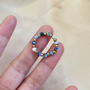 Handmade elastic beaded ring with blue marble stone, white beads and gold metal spacers