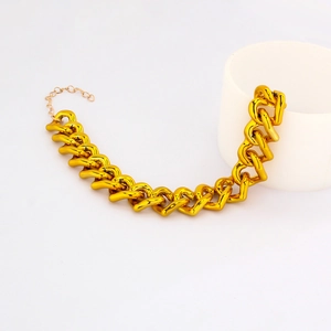 Close-up of hip hop style gold pet necklace on a white cylindrical display stand