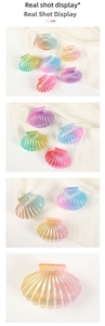 Detailed view of colorful shell-shaped hair claw clips with gradient pearlescent finish