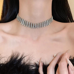 Detail of elegant silver layered rhinestone choker necklace on a model's neck for parties