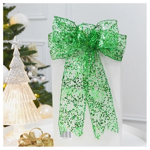 Macro detail of sparkly emerald green sequin mesh Christmas bow hanging on a gift box