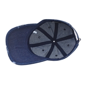 Close-up of distressed denim baseball cap showing inner sweatband and metal buckle