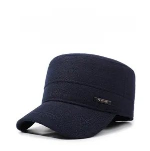 Detailed texture of thick navy wool winter flat cap with metallic FASHION emblem