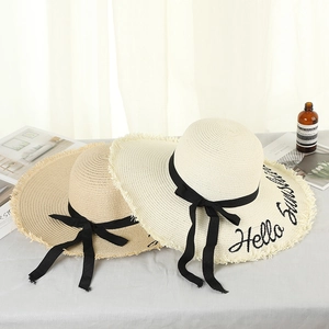 Detailed embroidery of Hello Sunshine text on wide brim straw hats with black ribbon bows