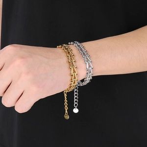 Detail of gold and silver bamboo link bracelets with adjustable chains on model