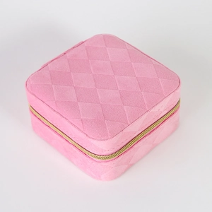 Top view of pink quilted velvet jewelry organizer box with a secure golden zipper closure