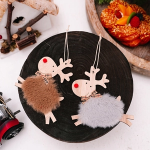 Detail of wooden reindeer ornaments with plush faux fur balls and festive plaid bows