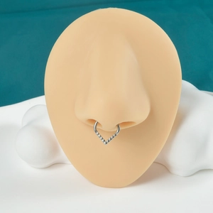 Detailed view of a silver V-shaped nose ring with studs on a silicone model