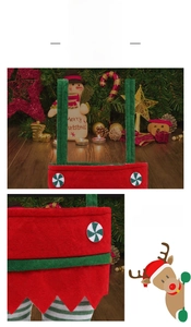 Detail of plush Christmas elf candy bag with striped handles and festive pom-poms