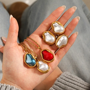 Baroque pearl necklaces and gold twist chain rings set with red and blue enamel inlays