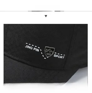 Detail of black baseball cap with JING PIN SPORT embroidery and mountain peak badge