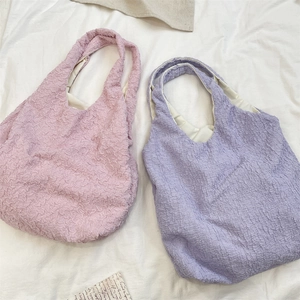 Detail of soft bubble textured fabric on light purple and pink casual tote bags