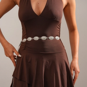 Detailed view of vintage silver metal waist chain with sunburst embossed oval charms