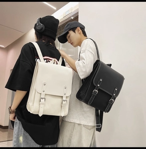Rear view of models wearing minimalist black and off-white retro leather backpacks