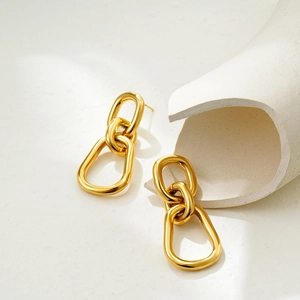 Close-up of triple interlocking gold oval hoops with a polished minimalist finish