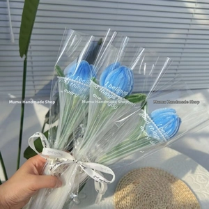 Close-up of handmade blue pipe cleaner tulip bouquet with Just For You ribbon wrapping
