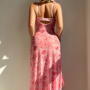 Pink floral sheer slip dress with backless cutout and cross-strap detail