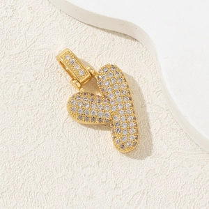 Close-up of gold plated chubby letter Y pendant with micro-pave cubic zirconia crystals