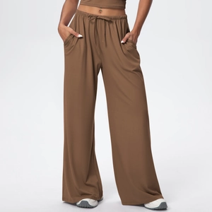 Detail of high waist brown wide leg pants with adjustable drawstring and side pockets
