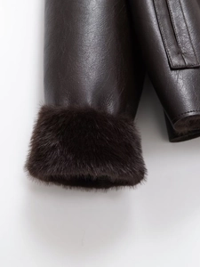Detailed close-up of dark brown faux leather sleeve with thick plush fur cuff trim