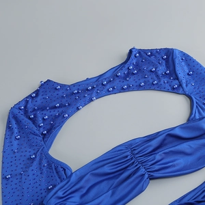Macro detail of royal blue dress featuring hand-stitched pearls and sequins for evening wear