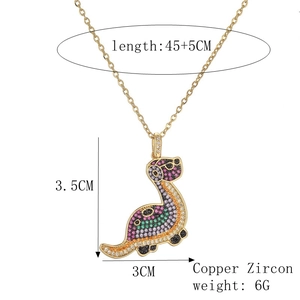 Detail view of 18k gold plated dinosaur necklace showing dimensions and copper zircon materials