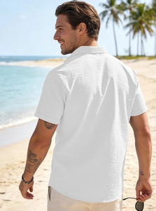 Rear view of a white linen short sleeve shirt for men at a sunny beach resort