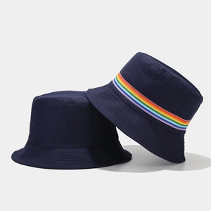 Detail showing high-quality navy blue canvas bucket hat with vibrant rainbow striped ribbon