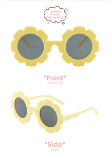 Close-up of yellow flower shaped sunglasses for kids with grey lenses and side details