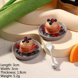 Macro shot of 3x3x1.8cm resin pancake miniatures with berries and syrup details